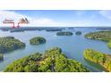 A scenic aerial view of Lake Lanier Islands, dotted with lush green islands at 7830 Kings Point Dr, Cumming, GA 30041