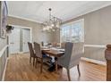 Elegant dining room with hardwood floors, modern lighting, and a large window with outside views at 1236 Brickton Nw Dr, Atlanta, GA 30318