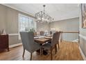 Open dining area with hardwood floors, stylish lighting, and easy access to the staircase at 1236 Brickton Nw Dr, Atlanta, GA 30318