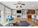 Cozy living room with fireplace, built-in shelving, ceiling fan and open access to the kitchen at 1236 Brickton Nw Dr, Atlanta, GA 30318