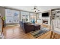 Bright living room with hardwood floors, fireplace, built-in shelving, and large windows at 1236 Brickton Nw Dr, Atlanta, GA 30318