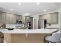 Modern kitchen featuring a large island, stainless steel appliances, and stylish cabinetry at 1827 Shaker Falls Ln, Lawrenceville, GA 30045