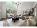 Bright, open living room with high ceilings and modern finishes flowing into the kitchen at 1827 Shaker Falls Ln, Lawrenceville, GA 30045