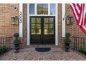 Close-up of stately front door, showcasing the address, detailed brickwork, and elegant lanterns at 3003 W Roxboro Rd, Atlanta, GA 30324