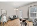 Cozy living room with wood floors, neutral paint, and large window at 6372 Rosetta Sw Dr, Atlanta, GA 30331