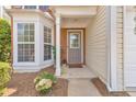 Inviting front porch featuring a gray door, a bay window and manicured landscaping at 1703 Bentridge Nw Dr, Kennesaw, GA 30144