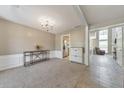 Cozy living room with carpet flooring, neutral walls, and an open doorway to the adjacent kitchen at 1703 Bentridge Nw Dr, Kennesaw, GA 30144