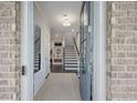 Inviting entryway with staircase and a light neutral color palette adding a modern and spacious look at 2062 Cortland Rd, Milton, GA 30009