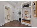 Mudroom with built-in storage, bench seating, decor and access to a bathroom with tiled floor at 2062 Cortland Rd, Milton, GA 30009