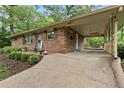 Quaint carport with a cozy outdoor deck area and decorative wrought iron details at 2337 Elmwood Se Cir, Atlanta, GA 30339