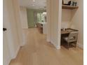 Bright hallway view leading to an open kitchen and dining area with hardwood floors at 324 Treble Way, Alpharetta, GA 30009
