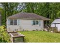 A home's backyard with a lush green lawn and raised garden beds at 1866 Tiger Flowers Nw Dr, Atlanta, GA 30314