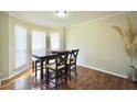 Bright dining area with hardwood floors and natural light streaming through the windows at 701 Monticello Ln, Mcdonough, GA 30253