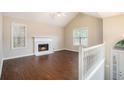 Bright living room with vaulted ceiling, hardwood floors, and fireplace with white mantle at 7832 Cambridge Dr, Douglasville, GA 30134
