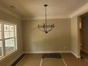 Bright dining room featuring modern chandelier and large windows offering great light at 877 Highway 101 N, Dallas, GA 30157
