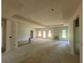 Expansive living room featuring a tray ceiling, fireplace, and multiple windows for natural light at 877 Highway 101 N, Dallas, GA 30157
