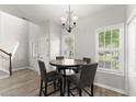 Bright dining area with new flooring, modern lighting, and large windows at 1237 Park Pass Way, Suwanee, GA 30024