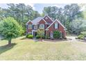 Charming red brick home featuring a well-manicured lawn and beautiful landscaping in a desirable community at 4319 Silver Peak Pkwy, Suwanee, GA 30024