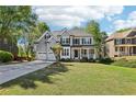 Charming two-story home featuring a manicured lawn, stone accents, and a two-car garage with mature landscaping at 4360 Havenridge Pl, Cumming, GA 30041