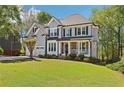 Charming two-story home featuring a manicured lawn, stone accents, and a two-car garage with mature landscaping at 4360 Havenridge Pl, Cumming, GA 30041