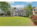 Charming two-story home featuring a manicured lawn, stone accents, and a two-car garage with mature landscaping at 4360 Havenridge Pl, Cumming, GA 30041