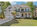 Beautiful two-story home with a well-maintained lawn, stone accents, and an attached two-car garage at 4360 Havenridge Pl, Cumming, GA 30041