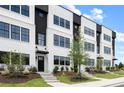 Stylish townhome exterior showcasing modern design with black trim and manicured landscaping at 439 Mezzo Ln # 88, Alpharetta, GA 30009