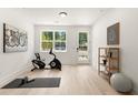 Bright exercise room has a stationary bike, yoga mat, and large window offering a view of the outdoors at 654 Soul Aly # 102, Alpharetta, GA 30009