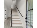 Inviting entryway features a staircase with dark wood and modern railings at 673 Soul Aly # 146, Alpharetta, GA 30009