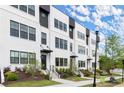 Modern townhome exteriors showcase stylish architecture, black window frames, and landscaped front yards at 673 Soul Aly # 146, Alpharetta, GA 30009