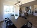 Dining room with modern lighting fixture, seating for six, and access to the patio at 3548 Cedarvale Ct, Powder Springs, GA 30127