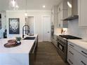 Modern kitchen with stainless steel appliances, a center island, and white subway tile backsplash at 3548 Cedarvale Ct, Powder Springs, GA 30127