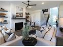 Bright and airy living room with white brick fireplace, floating shelves, and modern furnishings at 3548 Cedarvale Ct, Powder Springs, GA 30127
