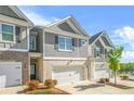 Beautiful townhome with a two-car garage, brick accents, and well-maintained landscaping at 7678 Gray Pointe Dr, Lithonia, GA 30058