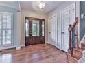 Elegant foyer showcasing a decorative glass front door, hardwood floors, and staircase leading to the upper level at 2347 Univeter Rd, Canton, GA 30115