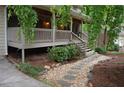 The front porch is framed by manicured landscaping, a stone pathway and a set of stairs at 553 Old Mill Ct, Norcross, GA 30093