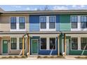 Street view showcases modern townhomes with unique colorful exteriors and covered front entrances at 1095 Tucker Ave # 503, Atlanta, GA 30310
