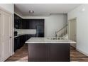 Contemporary kitchen with dark cabinets, a granite island, and stainless steel sink at 1800 Forkview Ct, Lawrenceville, GA 30044