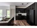 Modern kitchen featuring dark cabinets, stainless steel appliances, and granite countertops at 1800 Forkview Ct, Lawrenceville, GA 30044