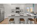 Bright kitchen boasts a large center island with seating and modern appliances at 4948 Jatoba Rd, Acworth, GA 30101