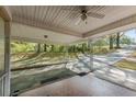 Spacious carport featuring metal supports, brick and tile entryway, and a ceiling fan at 618 Buchanan Hwy, Dallas, GA 30157