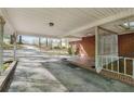 Spacious carport featuring metal supports, brick and tile entryway, and a ceiling fan at 618 Buchanan Hwy, Dallas, GA 30157