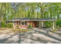 Charming single-story brick home with a spacious carport and mature trees at 618 Buchanan Hwy, Dallas, GA 30157
