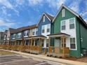 New colorful townhouses with front porches line the street, offering modern living at 1095 Tucker Ave # 408, Atlanta, GA 30310