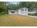 Attractive white home featuring a two-car garage, complemented by a well-kept front lawn at 3182 Wakefield Dr, Decatur, GA 30034
