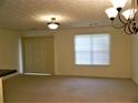 Bright living area featuring neutral carpet and a large window at 615 Magnolia Gardens Walk, Mcdonough, GA 30253