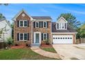 Charming two-story brick home boasts a manicured lawn, attached two car garage, and inviting curb appeal at 651 Deer Oaks Dr, Lawrenceville, GA 30044