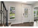 Elegant foyer with decorative door, dark wood flooring, decorative trim, and a view to the front yard at 651 Deer Oaks Dr, Lawrenceville, GA 30044