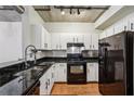 A modern, naturally lit kitchen featuring white cabinetry, granite countertops, and stainless steel appliances at 800 Peachtree Ne St # 2304, Atlanta, GA 30308