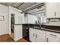 White cabinets and black granite countertops in this airy, naturally lit kitchen with open design at 800 Peachtree Ne St # 2304, Atlanta, GA 30308
